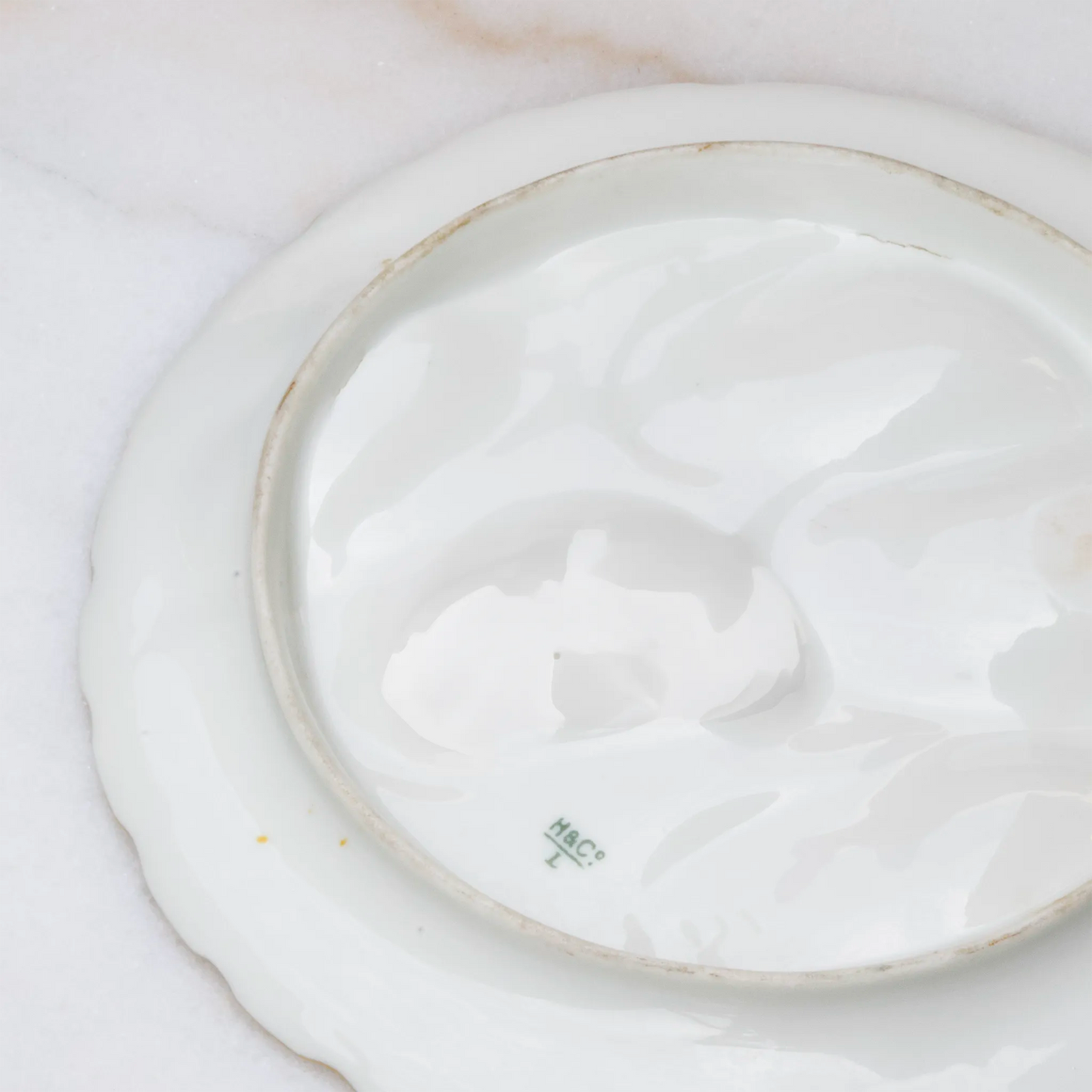 Limoges gold oyster plate reverse showing porcelain hallmark