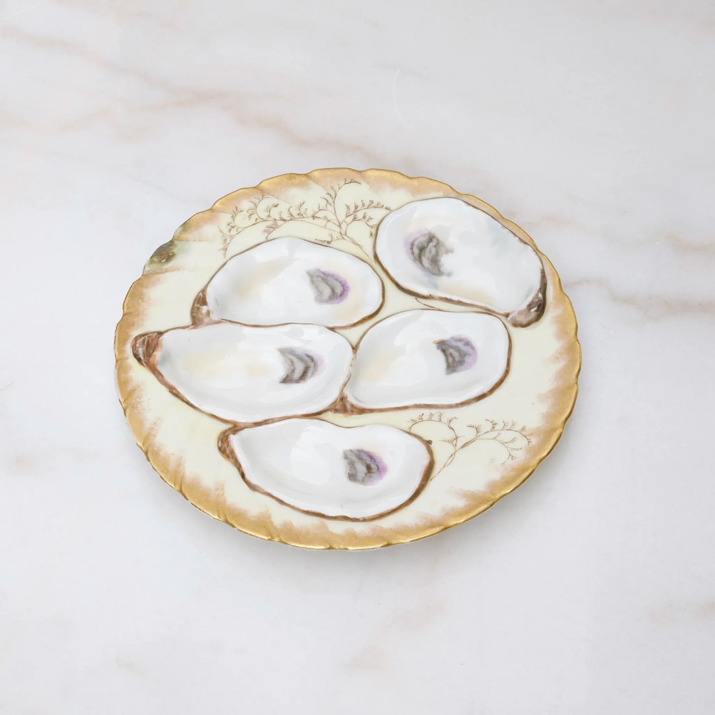 Limoges oyster plate with rich gold finish on scalloped wells