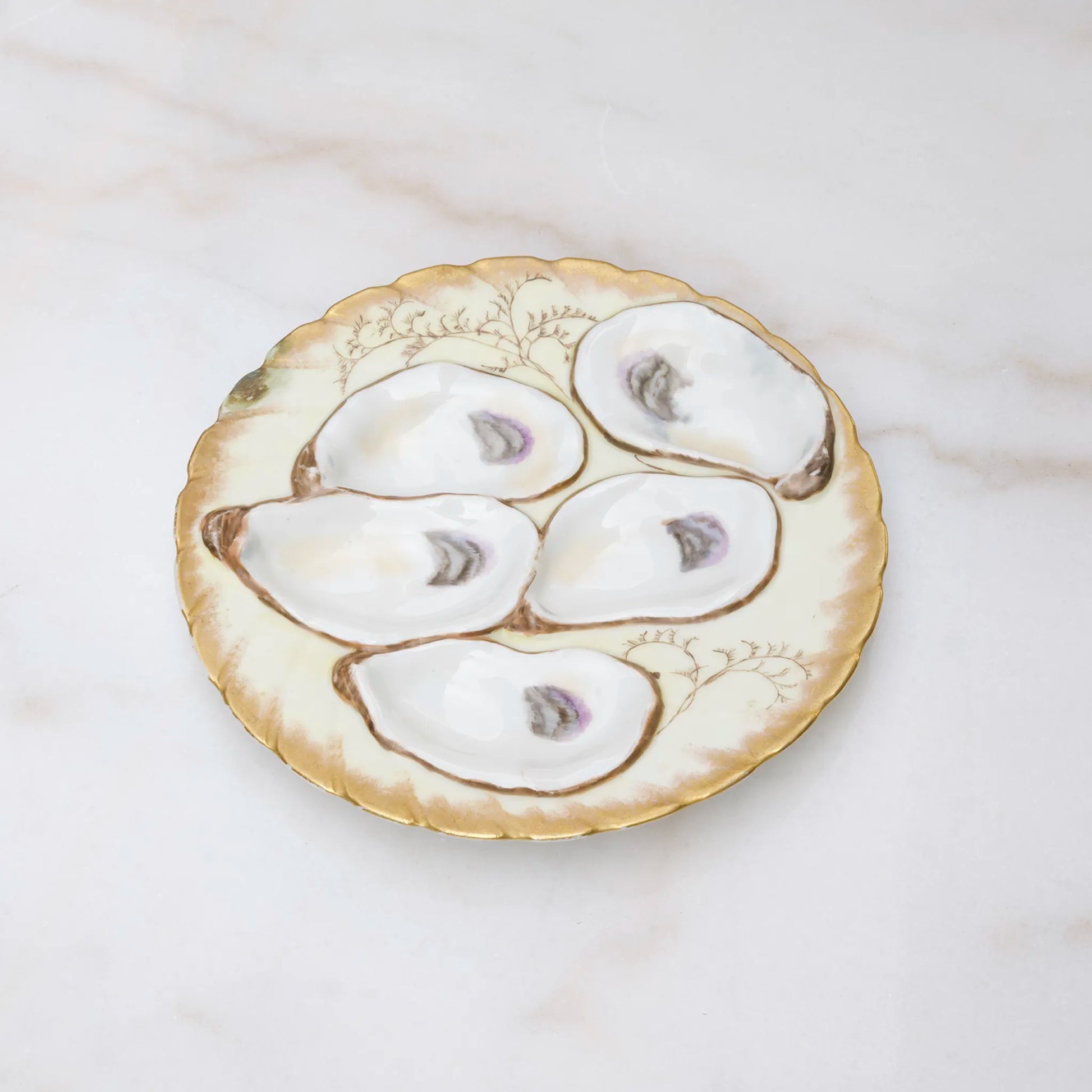 Limoges oyster plate with rich gold finish on scalloped wells