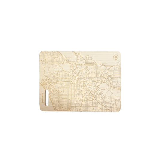 Well Told Los Angeles map engraved wooden cutting board with detailed city street grid design and handle cutout.